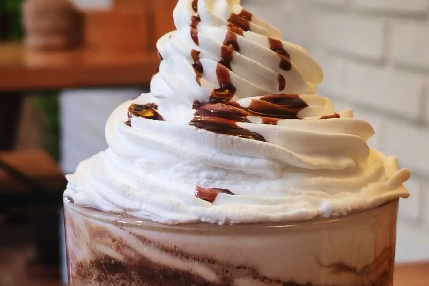 Blended frozen chocolate coffee drink topped with whipped cream and chocolate syrup