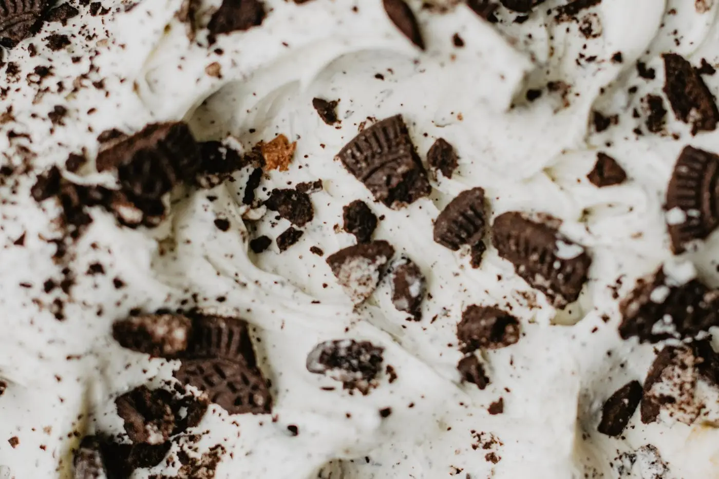 Close-up of creamy vanilla ice cream mixed with chocolate cookie pieces