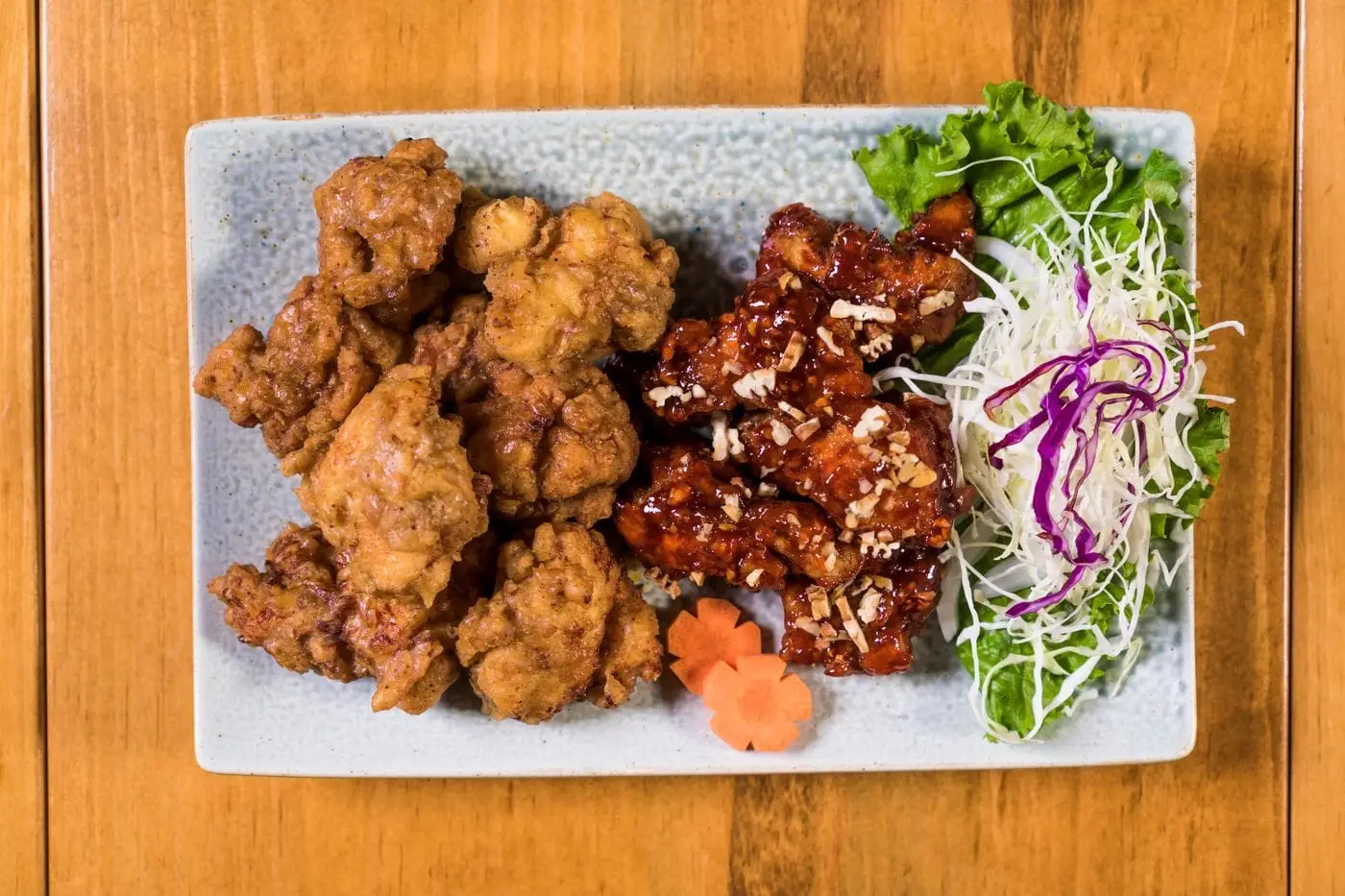 Crispy boneless fried chicken bites, plain and glazed, with shredded cabbage