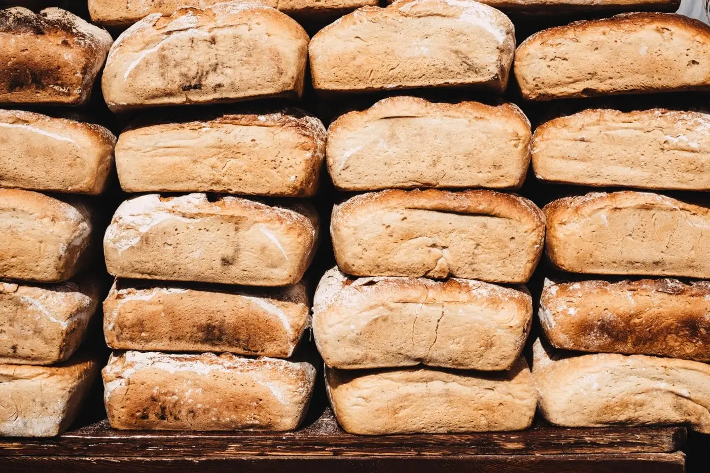 Stacked rows of freshly baked rustic bread loaves