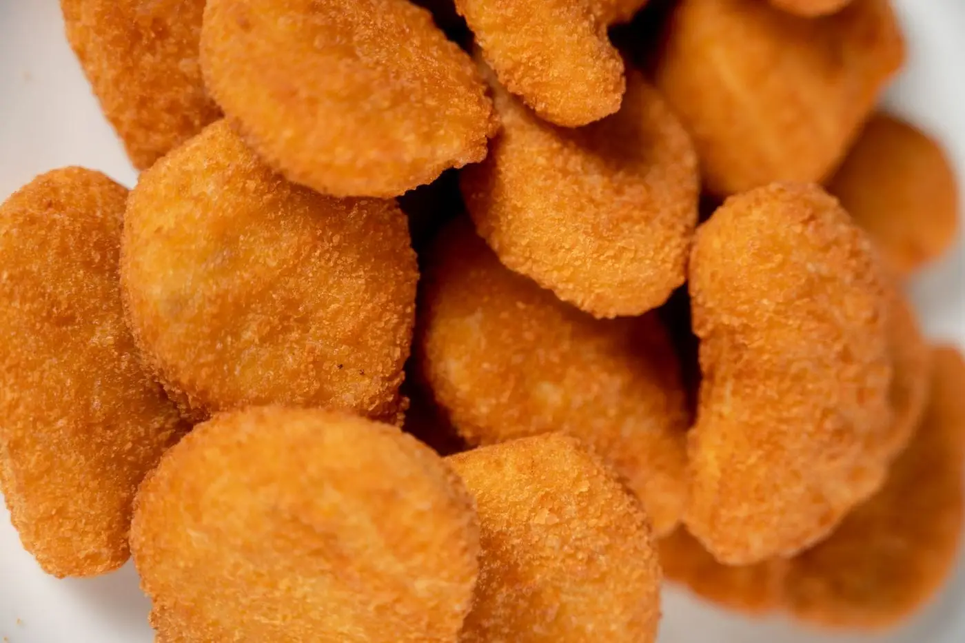 Close-up of a pile of golden breaded chicken nuggets