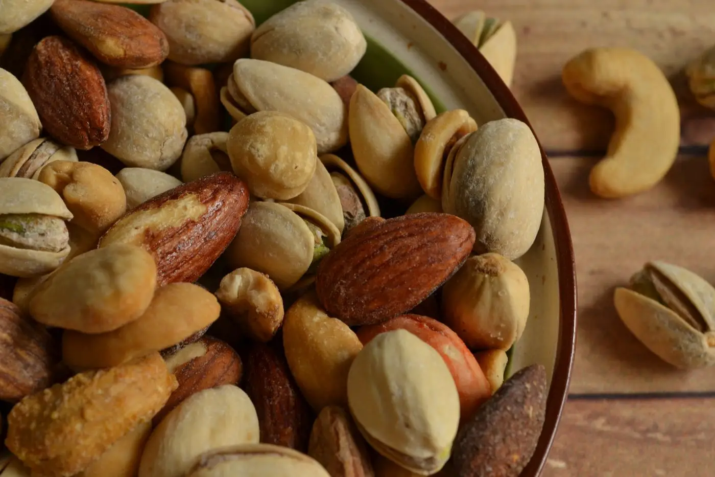 Bowl of mixed roasted nuts including almonds, pistachios and cashews