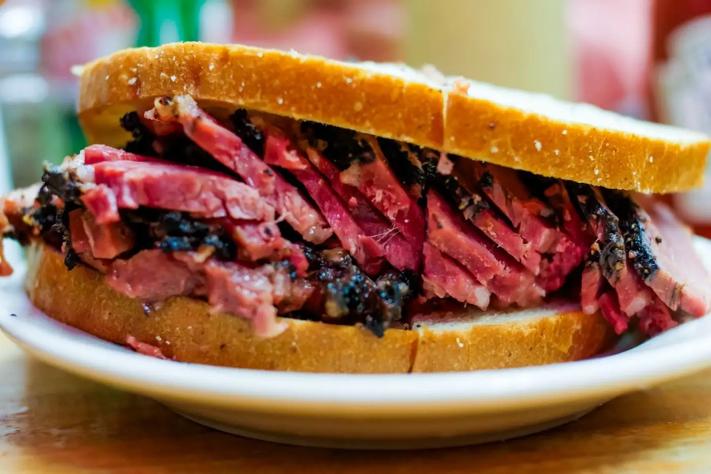 Sandwich piled high with thick slices of cured beef on white bread