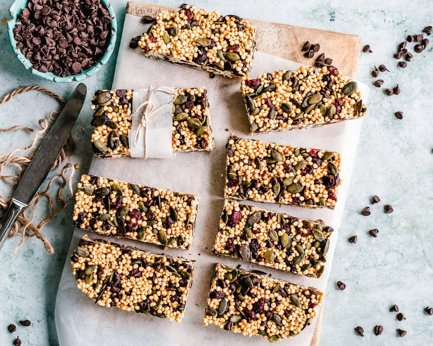 Homemade granola bars with pumpkin seeds, cranberries and chocolate chips on parchment